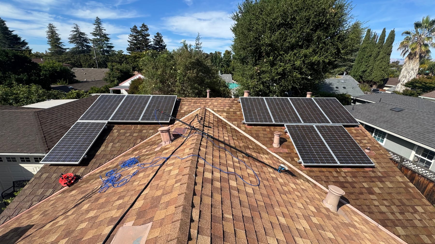 Clean dark solar panels on a tiled rooftop